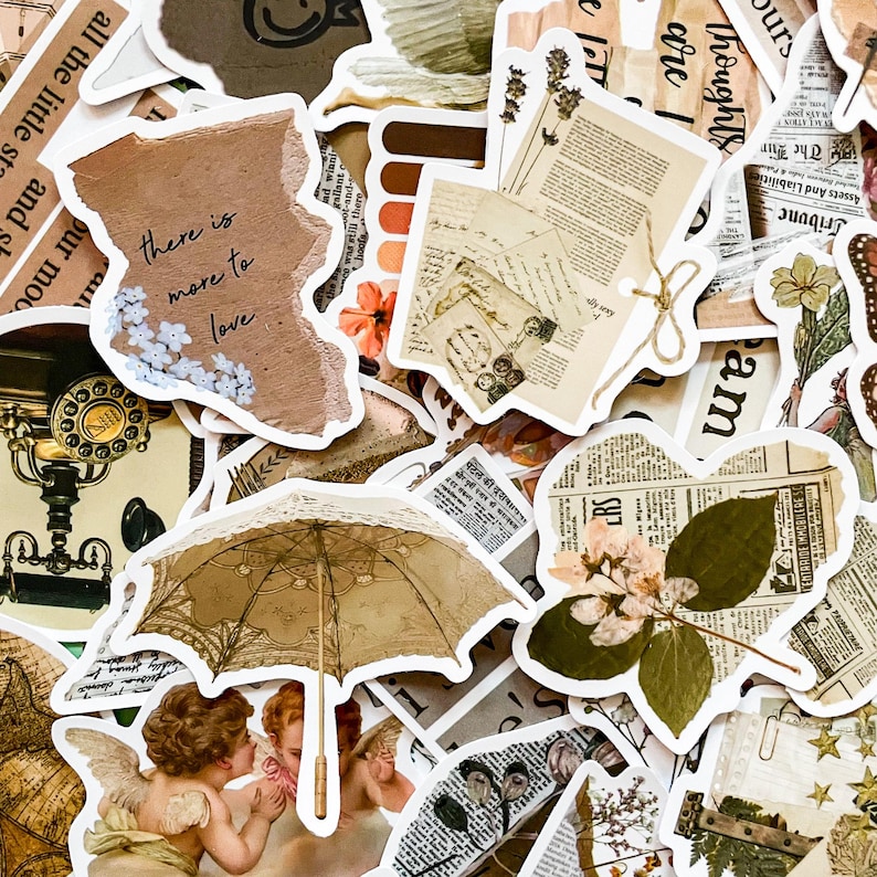 May include: A collection of vintage-style stickers with various designs. Includes a torn paper sticker with the text "there is more to love", a beige umbrella, and newspaper clippings. The color palette is primarily beige, brown, and white.
