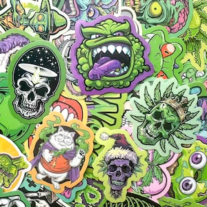 May include: A collection of colorful stickers with various designs. The stickers feature cartoon skulls, a cat in a cape, and other monster-like characters. The color palette includes green, purple, and black, with some stickers having a Christmas theme.