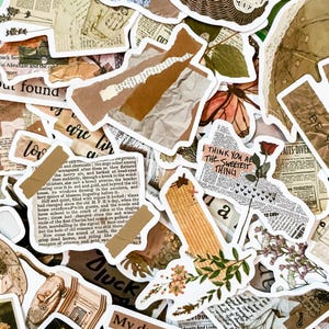 May include: A collection of vintage-style stickers with various designs. The stickers feature torn paper, floral elements, newspaper clippings, and handwritten text. Colors include beige, brown, and white, creating a collage aesthetic.