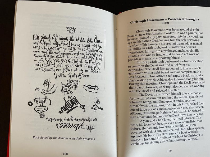 May include: An open book with white pages showing black text and illustrations. The left page features a handwritten document with symbols and the caption 'Pact signed by the demons with their promises.' The right page contains text titled 'Christoph Haizmann &ndash; Possessed through a Pact' and the page number 159.