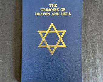 May include: A blue book with gold lettering and a gold Star of David. The text on the cover reads "THE GRIMOIRE OF HEAVEN AND HELL". The book is rectangular and has a textured surface.