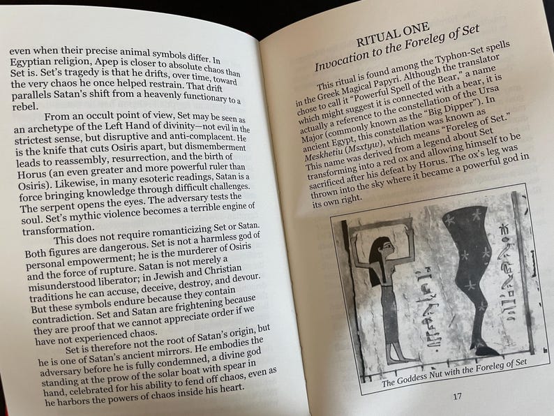 May include: An open book page featuring text titled RITUAL ONE Invocation to the Foreleg of Set. The page includes a black and white illustration labeled The Goddess Nut with the Foreleg of Set, depicting a figure and a leg symbol with stars.