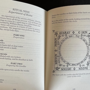 May include: An open book displaying pages 138 and 139, featuring black text on white paper. The left page details Ritual Nine, Experiment of Rome, listing materials and preparation steps. The right page shows a square diagram with a central circle.