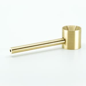 May include: A gold metal pipe with a long, straight stem and a round, flared bowl.