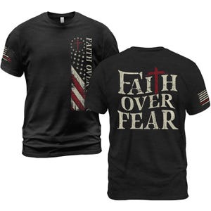 May include: Black t-shirts with the text "FAITH OVER FEAR" and a cross. One shirt features a vertical American flag design with the text "FAITH OVER" and a cross. The other shirt has the text and cross on the back.