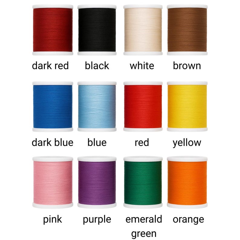 May include: A selection of thread spools in a range of colours: dark red, black, white, brown, dark blue, blue, red, yellow, pink, purple, emerald green, and orange. Each spool is labelled with its colour name.