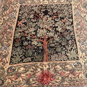 May include: A square tapestry featuring a tree design with a black background. The tree has brown branches and green leaves, with birds perched among the foliage. The border has floral and vine patterns in beige, red, and green.