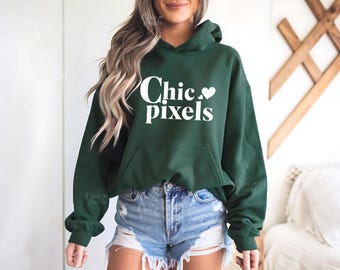 May include: A dark green hoodie with a white graphic that says "Chic. pixels" with a small heart symbol.