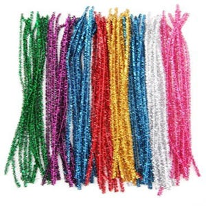 May include: An assortment of brightly coloured pipe cleaners in shades of green, purple, blue, red, gold, silver, and pink. These craft supplies are arranged in vertical bundles against a white backdrop.