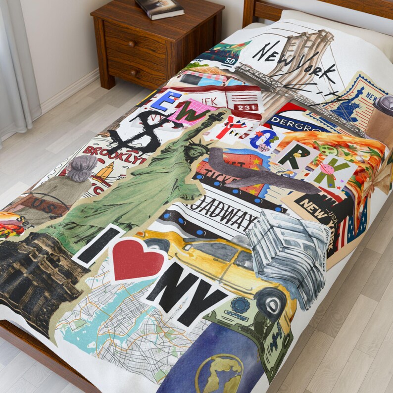 May include: A white bedspread featuring a collage of New York City imagery. The design includes the Statue of Liberty, a yellow taxi, the Brooklyn Bridge, and the words "I Love NY". The bedspread has a map and various other NYC-themed graphics.
