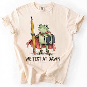 We Test at Dawn frog illustration T-shirt | teacher exam study shirt