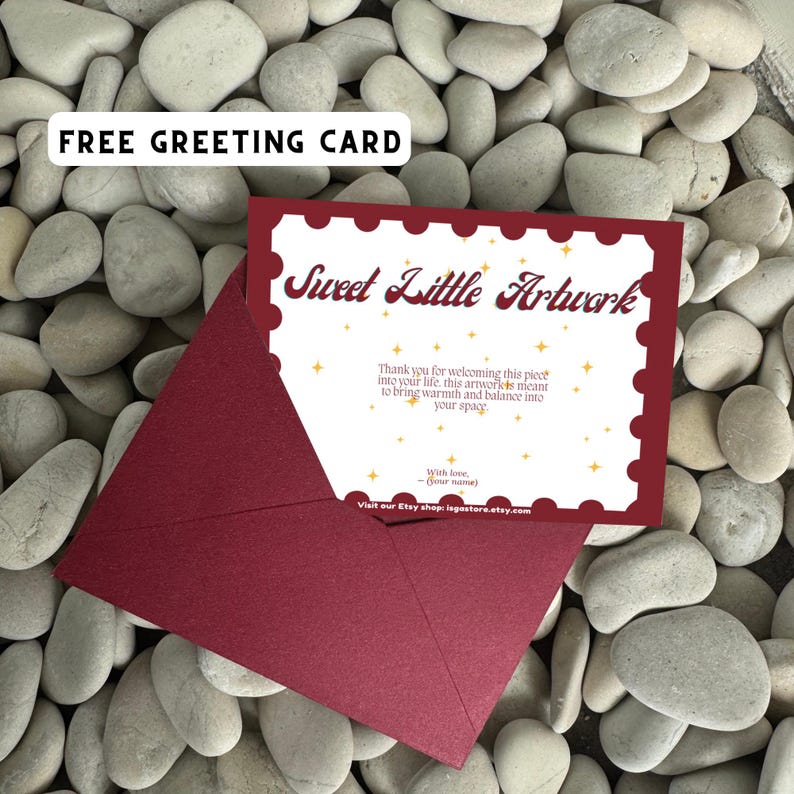 May include: A burgundy envelope with a matching greeting card that reads "Sweet Little Artwork". The card has a decorative border and text that thanks the recipient. The background is white stones.