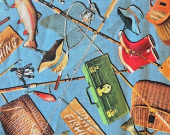 May include: A blue fabric featuring a fishing theme with various elements. The design includes fishing rods, reels, a net, a red fish, a green tackle box, and the words "GONE FISHING" on a sign. Other items include a hat, boots, and a basket.