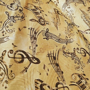 May include: A fabric with a musical theme. The background is a light tan color, with a pattern of musical notes, treble clefs, and piano keys in shades of brown and black. The fabric has a slightly wrinkled appearance.