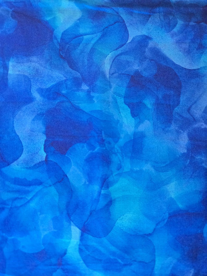 May include: Abstract textile pattern in shades of blue. The design features flowing, organic shapes in varying tones of azure, cerulean, and navy, creating a watercolor-like effect. The fabric appears soft and flowing.