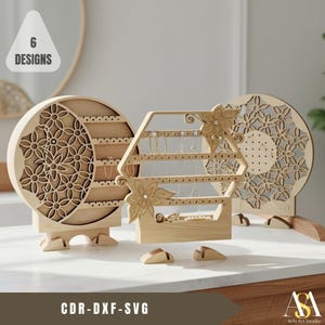 May include: Wooden jewelry organizers in various designs. The organizers include a crescent shape with floral cutouts, a hexagonal shape, and a round shape with floral cutouts. The image includes the text "6 Designs" and "CDR-DXF-SVG".
