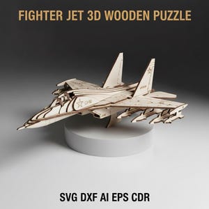 May include: A wooden fighter jet 3D puzzle. The model is light brown and features intricate details, including wings, a cockpit, and missile attachments. The text "FIGHTER JET 3D WOODEN PUZZLE" is at the top, and "SVG DXF AI EPS CDR" is at the bottom.