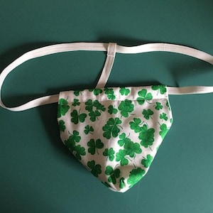 May include: White underwear with a green shamrock pattern and white elastic straps.