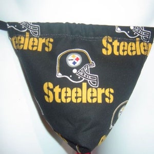 May include: Black and gold Steelers themed fabric thong with a football helmet graphic and the word "Steelers" repeated on the fabric.