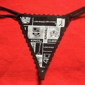 May include: Black lace lingerie with a white and black print featuring the Los Angeles Kings logo and team name.