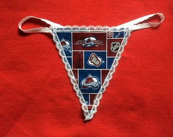May include: White lace trimmed underwear with a blue and red pattern featuring the Colorado Avalanche NHL team logo.