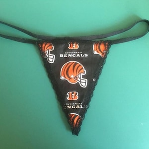 May include: Black lace thong underwear with a black and orange Cincinnati Bengals logo print.