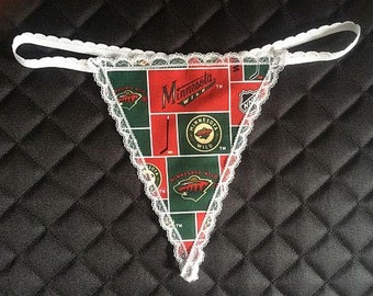 May include: White lace trimmed underwear with a green, red, and black patterned fabric featuring the Minnesota Wild hockey team logo and the NHL logo.