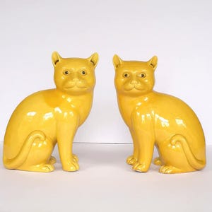 A Pair Of Chinese Yellow Glazed Porcelain Models Of Recumbent Cats, Late Qing/Republic Period