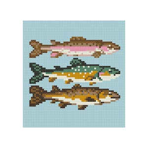 May include: Cross-stitch pattern featuring three pixelated fish: a brown and pink trout, a green and yellow fish, and a brown and yellow fish. The fish are set against a light blue background, creating a textured, handmade appearance.