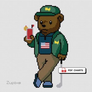 Könnte beinhalten: Kreuzstich-Design eines braunen Bären mit grüner Kappe und Jacke, der ein rotes Getränk mit einer Garnierung hält. Der Bär trägt Golfkleidung, mit einem Golfschläger und der amerikanischen Flagge auf seinem Hemd. Der Text "PDF CHARTS" ist sichtbar.