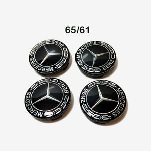 May include: Four black and silver Mercedes-Benz wheel centre caps with the Mercedes-Benz logo and text.