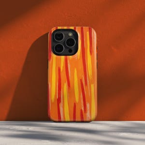 May include: A smartphone case with a vibrant abstract design. The case features a pattern of vertical brushstrokes in shades of orange, yellow, and red. The case is shown against an orange background.