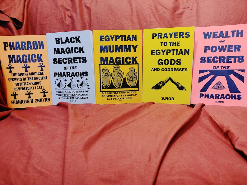 May include: Five paperback books with yellow, white, and pink covers. The books are titled "Pharaoh Magick", "Black Magick Secrets of the Pharaohs", "Egyptian Mummy Magick", "Prayers to the Egyptian Gods and Goddesses", and "Wealth and Power Secrets of the Pharaohs".