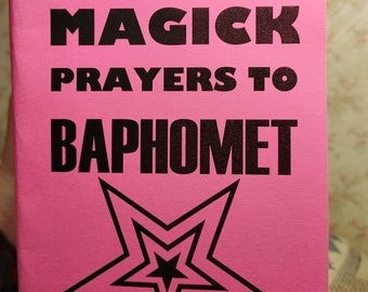 May include: A pink booklet with the title "Black Magick Prayers to Baphomet" in black text. A black five-pointed star with a smaller star inside is centered on the cover.