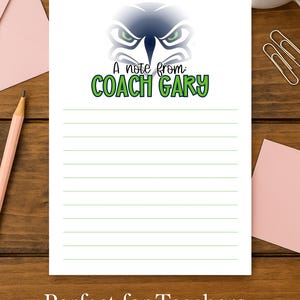 May include: White lined notepad with a green and blue graphic of a stylized face and the text "A note from: COACH GARY". The notepad is on a wooden surface with a pencil, pink envelope, and a cup of coffee.