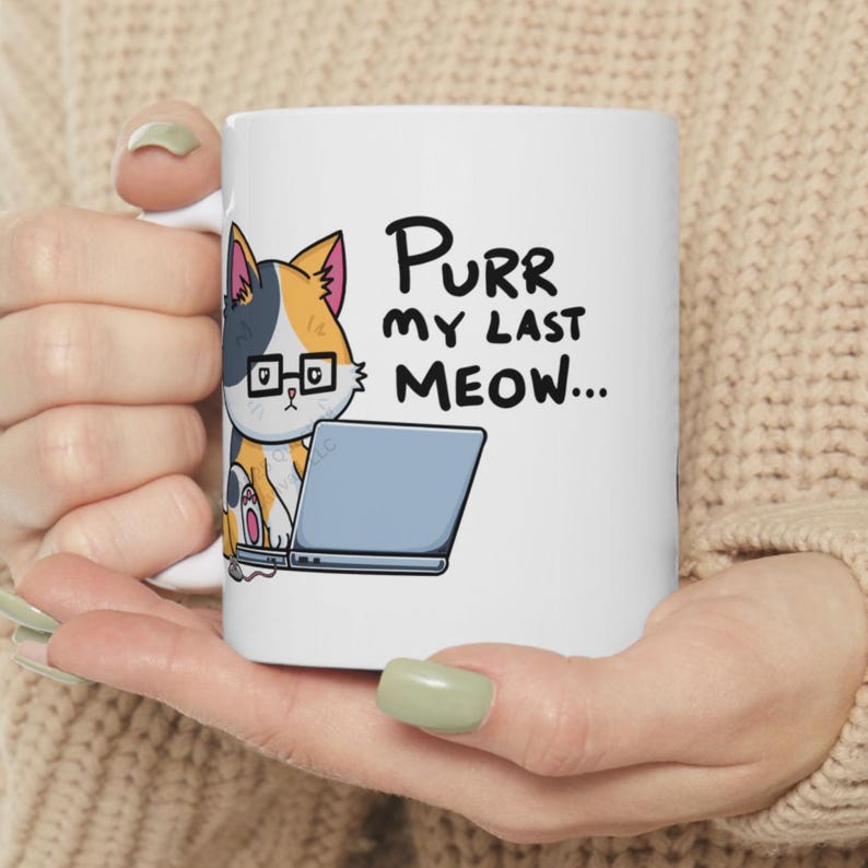 A funny design of a cat working on a computer. A cat wearing glasses sits in front of a laptop. Next to the cat on the floor is a little mouse with a 2 ears and a nose. Its tail connects into the side of the cat's laptop. The cat is looking down at the computer. The caption for the design says: "PURR MY LAST MEOW.” Perfect gift for the sarcastic coworker, employee recognition idea or team building gift.