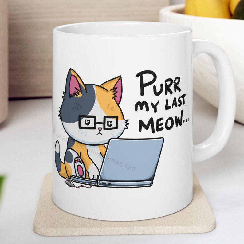 A funny design of a cat working on a computer. A cat wearing glasses sits in front of a laptop. Next to the cat on the floor is a little mouse with a 2 ears and a nose. Its tail connects into the side of the cat's laptop. The cat is looking down at the computer. The caption for the design says: "PURR MY LAST MEOW.” Perfect gift for the sarcastic coworker, employee recognition idea or team building gift.