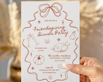 May include: A white Friendsgiving Dinner Party invitation card held by a hand. The card features a brown line drawing of a bow, a turkey, a pumpkin, and other festive elements. The text on the card reads "Join us for a Friendsgiving Dinner Party" and includes event details.