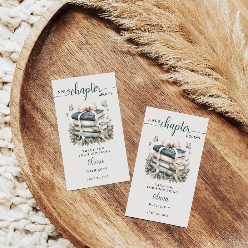 May include: Two rectangular cards with the text "A new chapter begins" and "Thank you for showering Olivia with love July 24, 2025". Each card features a watercolor illustration of stacked books tied with a bow and surrounded by flowers and butterflies.