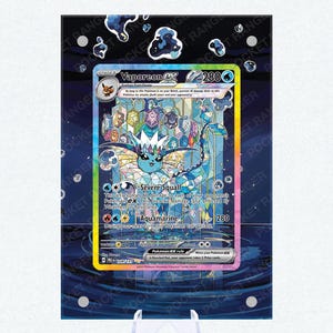 May include: A framed Vaporeon EX Pokémon card, featuring a blue and white aquatic creature. The card has a holographic background and the text "Severe Squall" and "Aquamarine". The card is displayed on a clear plastic stand.