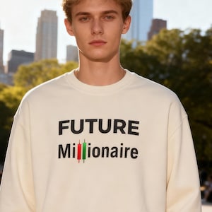 May include: Cream-colored sweatshirt with the text "FUTURE Millionaire" in black, with a red and green candlestick chart graphic. The sweatshirt is worn by a person standing in a park setting with a city skyline in the background.