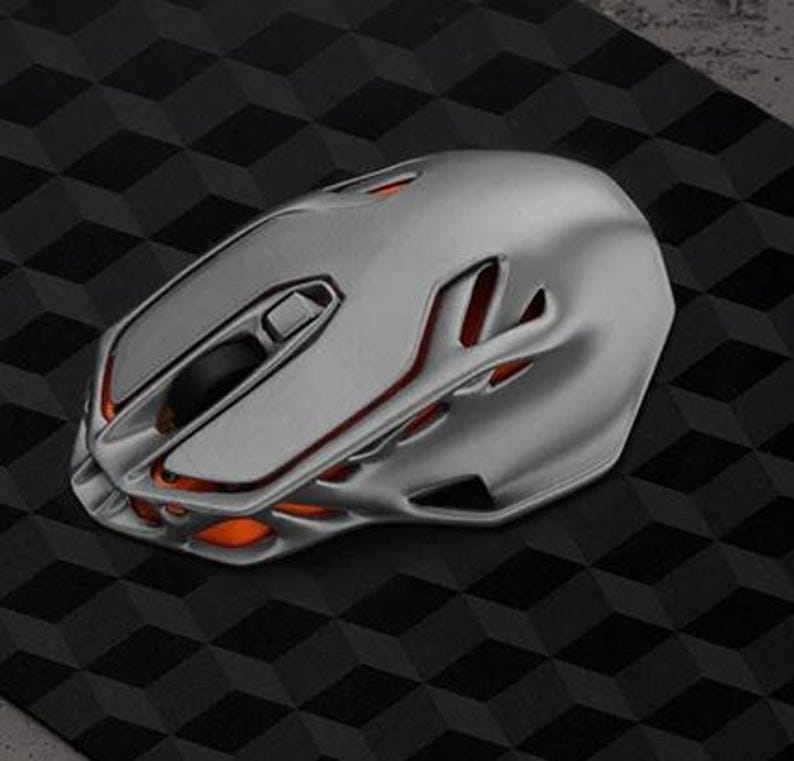 May include: A silver computer mouse with an orange accent and a futuristic design.