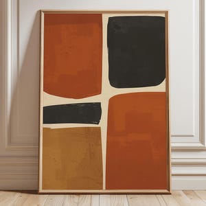 Peut inclure: Impression d'art abstrait encadrée. L'œuvre présente une composition en forme de croix avec quatre grandes formes irrégulières dans des tons rouille, noir et ocre, sur un fond crème. L'impression est affichée contre un mur blanc et un sol en bois.
