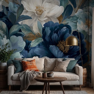 May include: A living room with a floral wallpaper featuring large blue and white flowers. A cream sofa is decorated with various coloured cushions. A wooden coffee table and a gold floor lamp complete the decor.