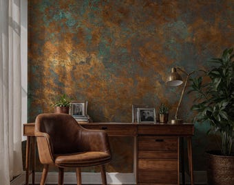 May include: A home office setup featuring a brown leather chair, a wooden desk with drawers, and a brass desk lamp. The background is a textured wall with shades of brown, copper, and teal. A potted plant and framed photos add to the decor.
