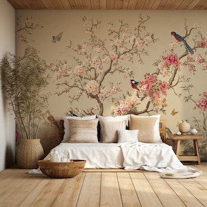May include: A serene bedroom scene featuring a floral mural with pink blossoms and birds. The room includes a bed with white linens, beige pillows, and a woven basket. Wooden floors and a small side table complete the tranquil setting.
