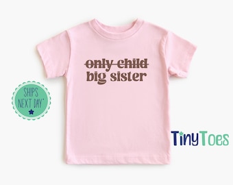 Koszulka z napisem „Big Sister Reveal”: ogłoszenie ciąży jedynaczki u rodzeństwa