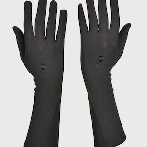 May include: A pair of long black gloves with a floral embroidery design.