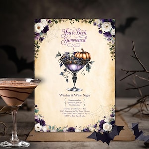 May include: Halloween-themed invitation with the text "You've Been Summoned." The invitation features a purple goblet filled with fruit and a pumpkin, surrounded by floral accents and spiderwebs. A chocolate martini is in the foreground.