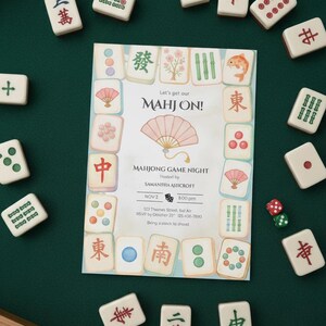 May include: A green felt surface with Mahjong tiles and a game night invitation. The invitation features a pink fan illustration and the text "MAHJONG GAME NIGHT" with event details. Dice are scattered nearby.